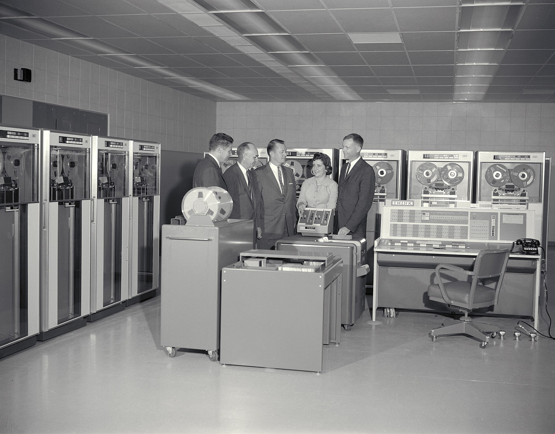 An IBM 7090 installation in 1961: tape drives along the wall and the operator's console